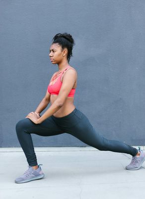 Side view of a person performing a slow, controlled lunge.